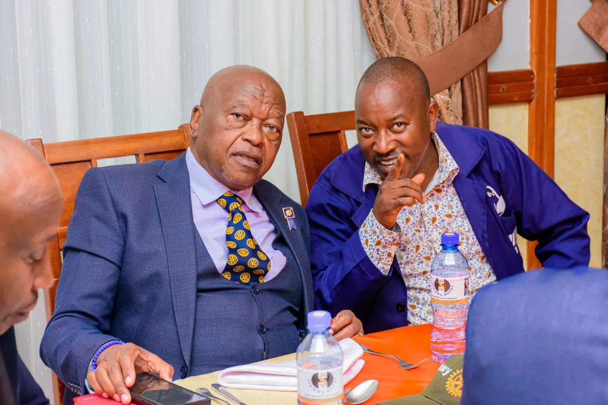Two members in conversation during a club meeting